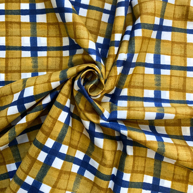A beautiful checked cotton lawn sewing fabric, from the wonderful KOKKA Fabrics. It has a subtle wavy black lines crossing water colour like mustard yellow lines against a white background. A soft, light weight fabric, with a bit of structure to it, making it easy to handle especially if you are early into your sewing journey. 