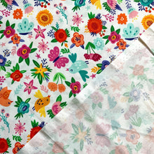 Load image into Gallery viewer, Introducing this wonderful quilting cotton weight fabric. It has a vibrant and colourful floral design with butterflies and birds. It has a lovely mix of colours such as pink, green, yellow, orange and white all against a deep blue background. The fabric can be used for craft and dressmaking. 
