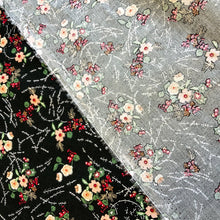 Load image into Gallery viewer, A cotton poplin fabric with a floral bouquet inspired design. The fabric has flowers in peach and white with little red flowers and green leaves against a black background and white lines and dashes between each bouquet. Cotton poplin has a smooth handle and a slight drape, it would be a perfect sewing fabric for dressmaking projects or craft.
