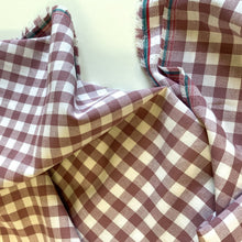 Load image into Gallery viewer, A lovely Mauve and white checked fabric. Gingham fabric is instantly recognisable and a firm favourite for many especially during the spring and summer months, but also popular into Autumn. Known for its checked patterns of white and a bold colour. It is extremely versatile, a great sewing fabric which can be used for shirts, dresses, craft and lightweight furnishing uses.  The checks are 10mm and appear in horizontal rows and vertical columns.
