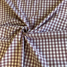 Load image into Gallery viewer, A lovely Mauve and white checked fabric. Gingham fabric is instantly recognisable and a firm favourite for many especially during the spring and summer months, but also popular into Autumn. Known for its checked patterns of white and a bold colour. It is extremely versatile, a great sewing fabric which can be used for shirts, dresses, craft and lightweight furnishing uses.  The checks are 10mm and appear in horizontal rows and vertical columns.
