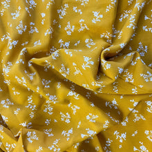 Load image into Gallery viewer, A wonderful yellow fabric with white flowers. A lovely dressmaking and sewing viscose fabric.
