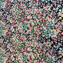 Load image into Gallery viewer, A wonderful Pima cotton lawn fabric, a high quality cotton lawn that features beautiful daisy like flowers in colours including peach, red, orange yellow and grey, just to name a few against a black background. Pima Cotton Lawn is a plain weave textile, with a crisp finish, it also has an added bonus of being extremely light weight, with a smooth silk like touch. You could make a multitude of items with this lovely fabric, and if dressmaking it would look amazing as a dress or top. 
