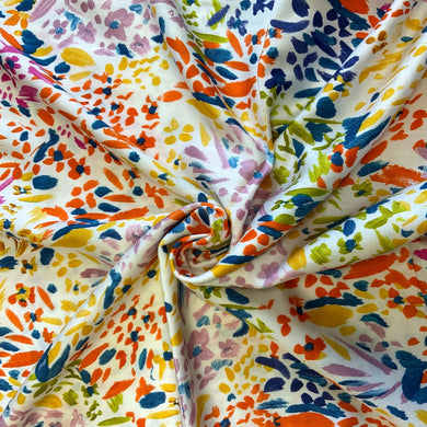 An amazing Viscose sewing fabric with a fun and bright design. The design has colourful dyed flowers with a painted effect and includes colours such as yellow, blue, red, orange, lilac and purple all against a white background. Viscose fabric is a semi-synthetic type of Rayon, made from wood pulp it gives a smooth silk like finish and as a light weight fabric will drape well across the body.
