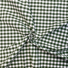 Load image into Gallery viewer, Gingham fabric is instantly recognisable and a firm favourite for many especially during the spring and summer months, but also popular into Autumn. Known for its checked patterns of white and a bold colour. It is extremely versatile, a great sewing fabric which can be used for shirts, dresses, craft and lightweight furnishing uses.  The checks are 10mm and appear in horizontal rows and vertical columns. This is a dark green gingham checked fabric
