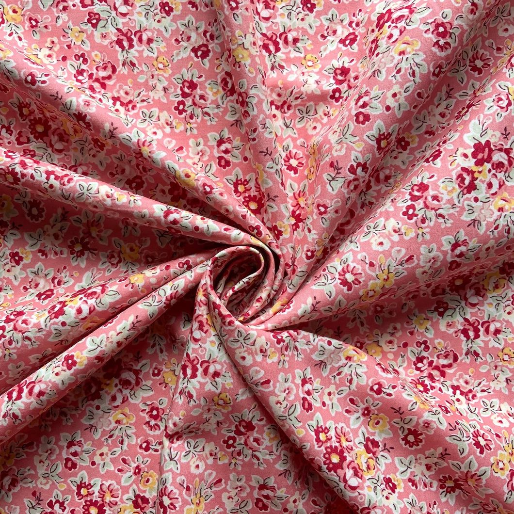 We have this amazing vibrant pink fabric with small flowers in deep red and pink colours, along with yellow and white with soft pale green leaves. 