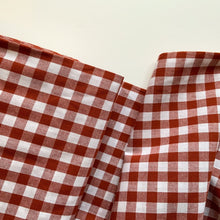 Load image into Gallery viewer, A lovely terracotta and white fabric. Gingham fabric is instantly recognisable and a firm favourite for many especially during the spring and summer months, but also popular into Autumn. Known for its checked patterns of white and a bold colour.
