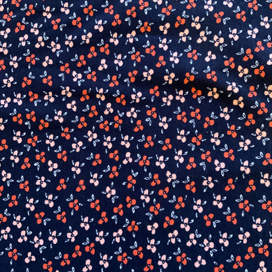 Introducing this wonderful jersey fabric by Poppy Designed for you Europe. This floral and organic jersey has various little daisy like flowers in peach and blush pink on a deep navy background. It is a medium weight cotton jersey and has a good stretch, and can be used for numerous garments, including t-shirts, sweatshirts, dresses, and leggings.