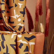 Load image into Gallery viewer, Discover Atelier Brunette&#39;s shadow ochre viscose modal, the new soft and supple material from their fragments collection. With fragmented shapeS in off white and dark navy against a wonderful vivid ochre background.
