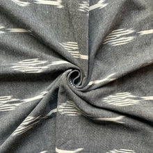 Load image into Gallery viewer, Introducing this wonderful washed woven Ikat Indian cotton. Made from a yarn dyed cotton, the fabric has medium sized blurry geometric shapes in white, against a stone grey coloured background. 
