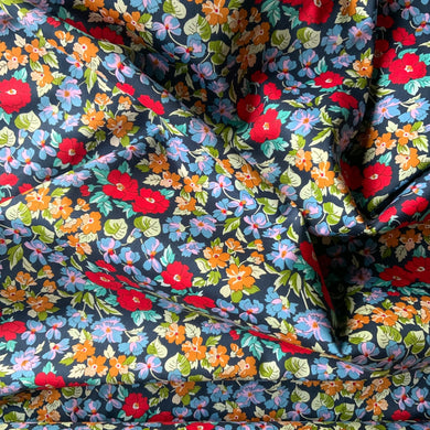Introducing this beautiful poppy like floral print cotton lawn. Amazing rich vivid colours with red poppy style flowers in various sizes taking centre stage, it also has flowers in blue, lilac and pink, and mustard yellow flowers all against a black background. Cotton lawn is a plain weave textile with a smooth finish, light in weight and also soft to the touch. A great fabric to work with, incredibly versatile and would suit dresses and blouses. 