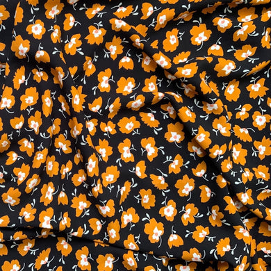 Floral Viscose sewing fabric to buy with yellow and white flowers on a black background
