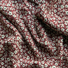Load image into Gallery viewer, A beautiful light weight viscose fabric great for dressmaking. It has small white flowers, with delicate black centres and leaves against a berry background, a great sewing fabric that works for all seasons.
