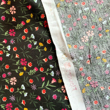 Load image into Gallery viewer, Part of the Poppy Fabrics range. A lovely cotton poplin fabric with an array of flowers, the floral print includes colours such as pink, yellow, white, lilac, purple and peach against a black background
