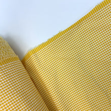 Load image into Gallery viewer, Introducing this amazing Italian deadstock sewing fabric. A lovely lemon yellow and white fabric. Gingham fabric is instantly recognisable and a firm favourite for many especially during the spring and summer months, but also popular into Autumn. Known for its checked patterns of white and a bold colour. Seersucker is a summery cotton fabric which has a puckered surface due to the alternate tight and loose yarns in the weaving process.
