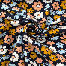 Load image into Gallery viewer, A lovely bright and soft floral jersey fabric with wonderful colours in yellow, white, light blue and peach with contrasting colours in the centre of each flower. Made from a lovely high quality organic cotton jersey fabric. A luxurious soft and comfy stretchy jersey fabric with a great weight, a perfect quality for sweatshirts, hoodies, pants and dresses.
