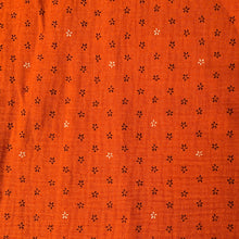 Load image into Gallery viewer, Double Gauze Fabric with stencil style daisies printed against a burnt orange background. Great for sewing and dressmaking
