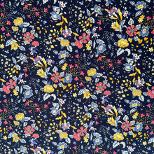 Load image into Gallery viewer, A cotton poplin fabric with a navy themed floral print. The design features vine like flowers with colours in yellow, pink and light blue against a navy background. With a crisp, smooth handle and a slight drape, it would be a perfect sewing fabric for dressmaking projects or craft.
