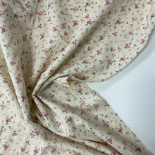 Load image into Gallery viewer, Introducing this amazing Italian deadstock sewing fabric. The fabric is from a lovely UK designer and is made of Cotton gauze. Cotton gauze is a muslin type fabric and created from a plain weave it is extremely light and breathable and would suit the summer months. This beautiful fabric has delicate pink flowers with green stems against a dark cream background. 
