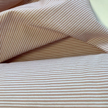 Load image into Gallery viewer, Introducing this amazing Italian deadstock sewing fabric. A simple design but lovely quality pastel pink and white striped stretch cotton fabric. The stripes are narrow with a slight embossed texture to the fabric surface. A great fabric which can be sewn up into something smart or casual, It is extremely versatile, a great sewing fabric which can be used for shirts, dresses, craft and lightweight furnishing uses.

