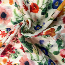 Load image into Gallery viewer, Introducing this amazing Italian deadstock sewing fabric. This is a wonderful linen and cotton mix fabric from a UK designer, with a beautiful floral design which looks painted and designed so it looks like it has run against an off white background. The fabric quality is lovely, with a strong sturdy handle but still provides some drape across the body. As it has a 42% cotton content it creases less but has the look and feel of linen, making it light and breathable.
